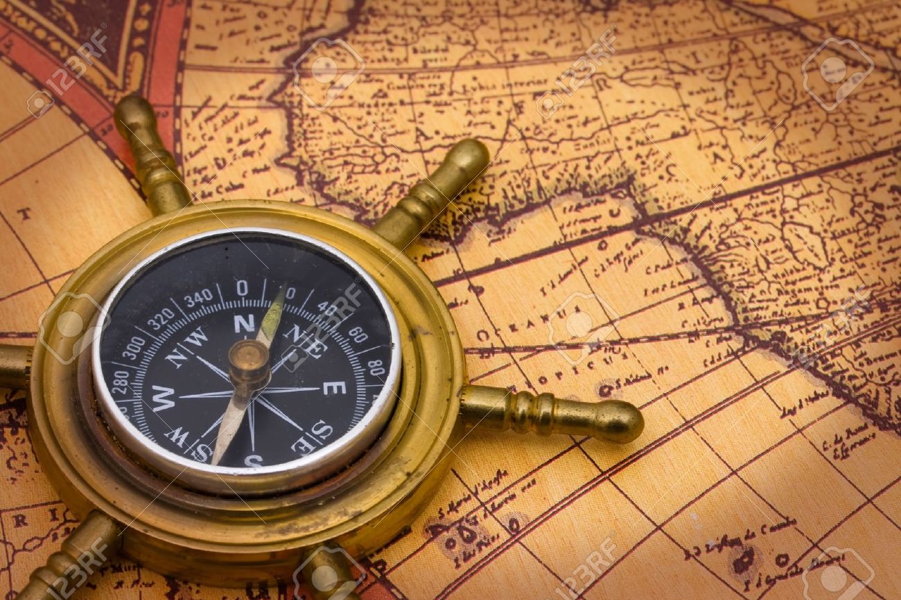6847754-A-compass-on-a-old-world-map-background-Stock-Photo.jpg